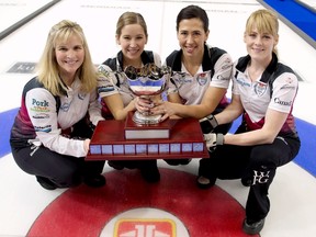 Team Jones skip Jennifer Jones, left to right, third Kaitlyn Lawes, second Jill Officer and lead Dawn McEwen pose with the trophy after defeating Team Homan at the Canada Cup of Curling final against Team Homan in Brandon, Man., on Sunday, Dec. 4, 2016. THE CANADIAN PRESS/HO - Michael Burns