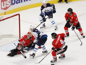 Bryan Little scores against Blackhawks goalie Scott Darling in the second period. (KAMIL KRZACZYNSKI/AP)