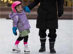 Henna Krupa, 4, gets a hand from her mom, Kathy Ochoa, as she skates for the second time in her life at the skating rink in front of City Hall on Sunday, December 4, 2016  in Edmonton. (Greg  Southam/Postmedia)