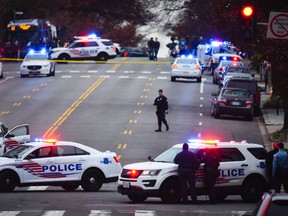 Police secure the scene near Comet Ping Pong in Washington, Sunday, Dec. 4, 2016. A man who said he was investigating a conspiracy theory about Hillary Clinton running a child sex ring out of the pizza place fired an assault rifle inside the restaurant on Sunday injuring no one, police and news reports said. (Photo by Sarah L. Voisin/The Washington Post via AP)