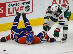 Oilers captain Connor McDavid is upended by Wild's Jared Spurgeon during second-period action in Sunday's game at Rogers Place. (Greg Southam)