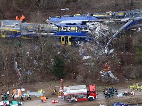 In this Feb. 9, 2016 file photo rescue teams work at the site where two trains collided head-on near Bad Aibling, Germany, killing twelve people and injuring 89. On Monday, Dec. 5, 2016 the train dispatcher was sentenced to 3 years and six months in prison because of negligence that led to one of the worst train crashes in German history. (AP Photo/Matthias Schrader, file)