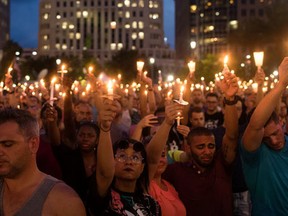 People hold candles during an evening memorial service for the victims of the Pulse Nightclub shootings, at the Dr. Phillips Center for the Performing Arts, June 13, 2016 in Orlando, Florida. (Drew Angerer/Getty Images)