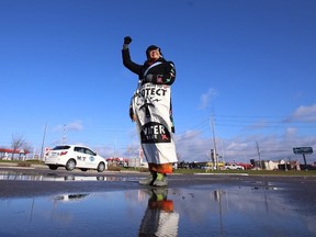 Ann Marie Kick-Proulx, who has both Chippewas and Oneida heritage, holds a sign calling on everyone to to protect water resources ahead of a celebration rally in support of the work done by protestors and activists to halt work on a pipeline through Sioux land in North Dakota. The rally will see people March onto the Wellington Road overpass at Highway 401 where a prayer will be held at noon. (CRAIG GLOVER, The London Free Press)