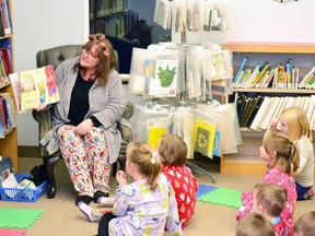 DeAnna Schouwstra (left), coordinator of kids programs at the West Perth Public Library, reads a story to the kids who dressed in their pyjamas for the Sleepyhead Storytime event last Wednesday, Nov. 30. GALEN SIMMONS MITCHELL ADVOCATE