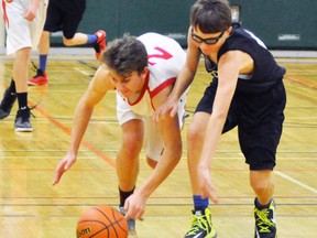 Josh Eidt (right) a call-up from elementary school to play with the MDHS junior boys Grade 9 basketball team, races with a Woodstock CI opponent for a loose ball during preliminary action from the Mitchell junior boys tournament at Upper Thames elementary school. ANDY BADER MITCHELL ADVOCATE