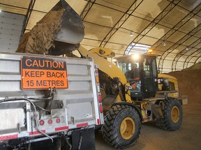 A sand spreader is loaded with sand at the city's north district sand storage site on Monday in preparation for an overnight snowstorm. (Brian Donogh/Winnipeg Sun)