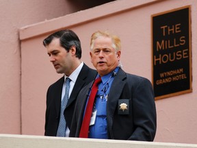 Michael Slager, left, walks from The Mills House Hotel to the Charleston County Courthouse under the protection from the Charleston County Sheriff's Department during a break in the jury deliberations for his trial Monday, Dec. 5, 2016, in Charleston, S.C. Former North Charleston police officer, Slager, is charged with murder in the shooting death last year of Walter Scott. (AP Photo/Mic Smith)