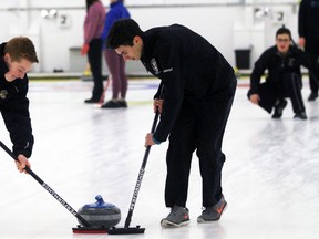 Northern Vikings second Shaun McDermott, left, and lead Hendrik Lindhout sweep while skip Joseph Iaccino instructs them during Lambton Kent high school boy's curling at the Sarnia Golf and Curling Club on Monday, Dec. 5, 2016 in Sarnia, Ont. Northern lost 9-3 to the St. Patrick's Fighting Irish. (Terry Bridge/Sarnia Observer/Postmedia Network)