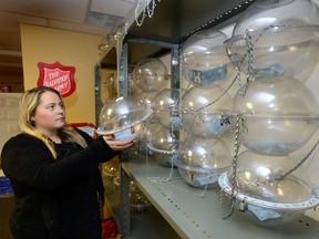 Shannon Wise, spokesperson for the Salvation Army, stacks the Salvation Army kettles in the storage room of their King Street headquarters. The Salvation Army is experiencing a shortage of volunteers to work collecting donations in the annual Christmas campaign. (MORRIS LAMONT, The London Free Press)