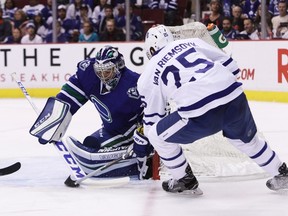 Vancouver Canucks goaltender Ryan Miller (20) makes a save against Toronto Maple Leafs' James van Riemsdyk (25) during first period NHL hockey action, in Vancouver on Saturday, December 3, 2016. THE CANADIAN PRESS/Ben Nelms