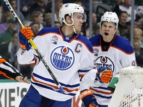 Edmonton Oilers center Connor McDavid (97) and Jesse Puljujarvi (98) of Sweden celebrate a goal by McDavid in the second period of an NHL hockey game against the Dallas Stars on Saturday, Nov. 19, 2016, in Dallas. The score was McDavid's second of the game. (AP Photo/Tony Gutierrez)