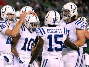 Indianapolis Colts quarterback Andrew Luck, left, celebrates with wide receiver Donte Moncrief (10) after the two connected for a touchdown pass during the second half of an NFL football game against the New York Jets, Monday, Dec. 5, 2016, in East Rutherford, N.J. (AP Photo/Seth Wenig)