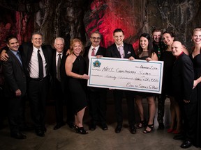 Members of Miners for Cancer and G-Rant, of Newcap Radio’s Hot 93.5 FM, hold a $20,000 cheque that will go towards renovating the chemotherapy suites at the Northeast Cancer Centre in Sudbury, Ontario. Supplied photo