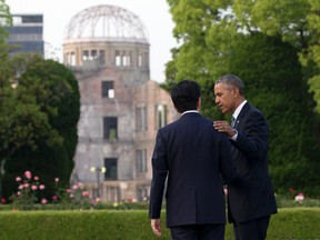In this Friday, May 27, 2016, file photo, U.S. President Barack Obama and Japanese Prime Minister Shinzo Abe speak with the Atomic Bomb Dome seen at rear at the Hiroshima Peace Memorial Park in Hiroshima, western Japan. U.S. President Barack Obama risked criticism at home when he decided to visit the memorial to the 140,000 killed in the atomic bombing of the Japanese city during the Second World War. Japanese generally welcomed his visit and praised his speech which called on humankind to prevent war and pursue a world without nuclear weapons. (AP Photo/Carolyn Kaster, File)