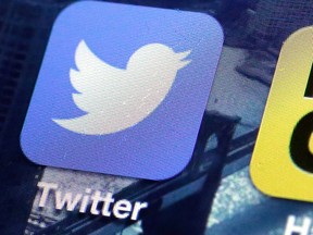 This Friday, Oct. 18, 2013, file photo shows a Twitter app on an iPhone screen, in New York. Twitter reports quarterly financial results on Tuesday, July 29, 2014. (AP Photo/Richard Drew, File)