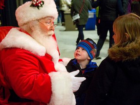 Caylan Cran, 3 of Strathroy has all his attention fixed on Santa Claus while his sister Carly, 6 hangs back a little at the annual Christmas craft show at the Western Fair Agriplex Sunday. The large show which has been running for 37 years features over 180 artisans, as well as a jolly old elf in London. (MIKE HENSEN, The London Free Press)