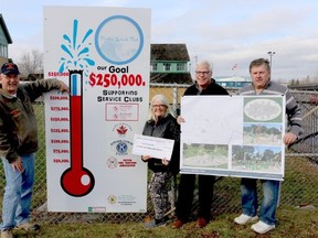 BRUCE BELL/The Intelligencer
Picton Splash Pad committee members (from left) Phil St. Jean, Susan Quaiff, Scott Wentworth and Kevin Gale are pictured at the project fundraising sign at the Picton Fairgrounds on Tuedsday morning. Quaiff is holding a $75,000 cheque from the Parrott Foundation, bringing the total to date to $206,000.