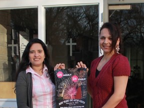 Organizers Nayi Rincon and Claudia Martinez hold up a poster for the Catholic Hispanic Community of Sarnia-Lambton's first-ever New Year's Eve Latin Fiesta, which takes place at St. Thomas Aquinas Parish Hall on Dec. 31.
CARL HNATYSHYN/SARNIA THIS WEEK