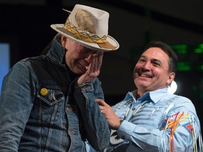 Assembly of First Nations Chief Perry Bellegarde holds an emotional Gord Downie as he is given an aboriginal name during a ceremony honouring Downie at the AFN Special Chiefs assembly in Gatineau, Que., on Tuesday. (Adrian Wyld/The Canadian Press)