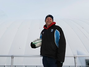 U of A women's rugby coach Matt Parrish poses in front of Foote Field, covered for the winter by an inflatable dome. (Ian Kucerak)