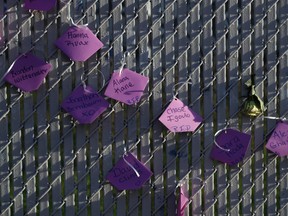 Victims names are written on a fence at a makeshift memorial near the site of a warehouse fire Tuesday, Dec. 6, 2016, in Oakland, Calif. (AP Photo/Marcio Jose Sanchez)