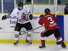 Sarnia Legionnaires forward Alec DeKoning keeps his eye on an airborne puck near Leamington Flyers defenceman Nicolas Mainella during the Greater Ontario Junior Hockey League game at Sarnia Arena on Tuesday, Dec. 6, 2016 in Sarnia, Ont. Leamington won 2-1 in overtime. (Terry Bridge/Sarnia Observer/Postmedia Network)