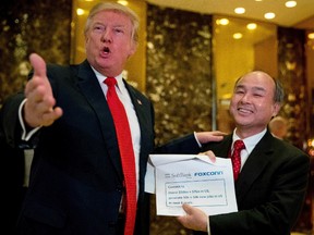 President-elect Donald Trump, accompanied by SoftBank CEO Masayoshi Son, speaks to members of the media at Trump Tower in New York, Tuesday, Dec. 6, 2016. (AP Photo/Andrew Harnik)