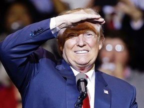 President-elect Donald Trump shades his eyes while looking at supporters during a rally in Fayetteville, N.C., Tuesday, Dec. 6, 2016. (AP Photo/Gerry Broome)