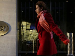A woman passes Pfizer's world headquarters, in New York. (AP Photo/Mark Lennihan, File)
