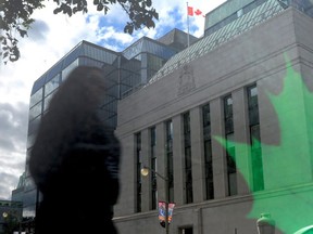 The Bank of Canada is reflected in signage on a bus stop in Ottawa on Tuesday, September 6, 2011.  (THE CANADIAN PRESS/Sean Kilpatrick)