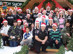 A group of 14 youth were escorted by 30 Kingston Police officers for the second annual Shop with a Cop event at the Cataraqui Centre in Kingston, Ont. on Wednesday December 7, 2016. The youth were asked to write a submission answering the question, "What makes Kingston awesome?" The winners were then presented a $200 mall gift card to purchase Christmas gifts for their families and themselves. Steph Crosier/Kingston Whig-Standard/Postmedia Network
