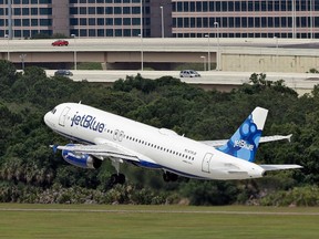 In this Thursday, May 15, 2014, file photo, a JetBlue Airways Airbus A320-232 takes off from the Tampa International Airport in Tampa, Fla. (AP Photo/Chris O'Meara, File)