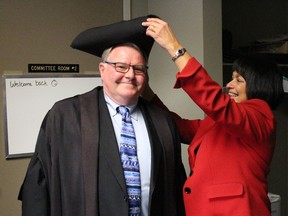 Newly-elected Lambton County Warden Bill Weber gets outfitted with the traditional tricorne hat by outgoing warden Bev MacDougall Wednesday. Weber -- the mayor of Lambton Shores -- became the county's 157th warden following a secret vote of county council. Petrolia Mayor John McCharles was elected by council Wednesday as deputy warden. (Barbara Simpson/Sarnia Observer)