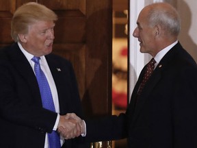 President-elect Donald Trump shakes hands with retired Marine Gen. John Kelly, right, at the Trump National Golf Club Bedminster clubhouse Sunday, Nov. 20, 2016, in Bedminster, N.J.. (AP Photo/Carolyn Kaster)