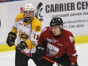 Sarnia Sting forward Cameron Hough, left, battles for body position with Guelph Storm defenceman Levi Tetrault during the Ontario Hockey League game at Progressive Auto Sales Arena on Wednesday, Dec. 7, 2016 in Sarnia, Ont. Hough, 16, made his OHL debut. (Terry Bridge/Sarnia Observer/Postmedia Network)