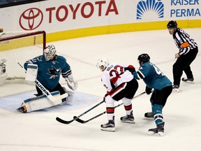 Chris Kelly of the Ottawa Senators scores a goal on Martin Jones, left, of the San Jose Sharks while defended by Marc-Edouard Vlasic, right, of the San Jose Sharks in the third period SAP Center on December 7, 2016 in San Jose, California. (Photo by Ezra Shaw/Getty Images)