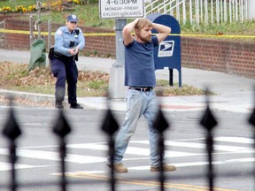 Edgar Maddison Welch, 28, of Salisbury, N.C., surrenders to police Sunday, Dec. 4, 2016, in Washington. Welch, who said he was investigating a conspiracy theory about Hillary Clinton running a child sex ring out of a pizza place, fired an assault rifle inside the restaurant on Sunday injuring no one, police and news reports said. (Sathi Soma via AP)