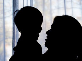 A mother and her son from northern B.C., who can't be identified, pose for a photograph after being reunited in Vancouver, on Tuesday December 6, 2016. The British Columbia Ministry of Children and Family Development seized the woman's two children in October, for the second time, because of unexplained breaks in her son's legs. Since he was a baby, he has suffered at least a dozen broken bones. The ministry is now officially returning the kids to their parents' care. THE CANADIAN PRESS/Darryl Dyck