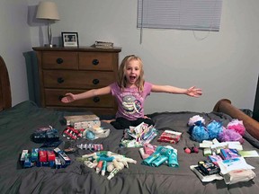 Seven-year-old Reese Russell shows off her haul of toiletries donated by community members. The Grade 3 student is preparing care packages for people in need this Christmas and, based on the response so far, is expecting to reach about 100 homeless individuals.