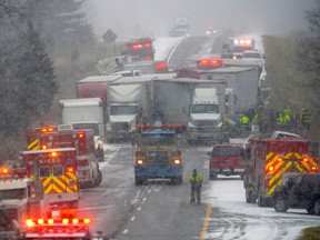 Emergency crews work the scene of a multiple car pileup on I-96 between Webberville and Fowlerville, Mich., Thursday, Dec. 8, 2016. (Dave Wasinger/Lansing State Journal via AP)