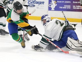Gino Donato/Sudbury Star
Braeden Tulini of the Lockerby Vikings tries to jam the puck past Confederation Chargers goalie Connor Sauve during boys high school hockey action on Tuesday.