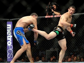 Tim Kennedy connects with a kick on Roger Gracie during their UFC 162 middleweight bout at the MGM Grand Garden Arena on July 6, 2013 in Las Vegas. (AP Photo/David Becker)