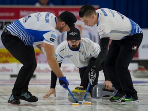 Team Carruthers skip Teid Carruthers, centre, lead Colin Hodgson, right, and second Derek Samagalski play in the Home Hardware Canada Cup on Curling on Dec. 4, 2016 in Brandon. (Michael Burns/Curling Canada)