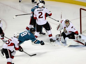 Senators goalie Mike Condon makes a save on a shot taken in close by Sharks forward Joe Pavelski during Wednesday night’s game in San Jose. (GETTY IMAGES)