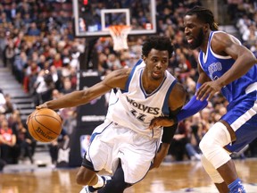 Minnesota’s Andrew Wiggins drives against the Raptors’ DeMarre Carroll during last night’s game. (MICHAEL PEAKE/Toronto Sun)