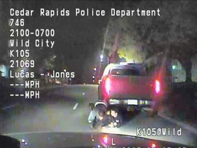 In this image made from a Nov. 1, 2016 dashcam video released Thursday, Dec. 8, 2016, by Cedar Rapids Police Department, an unarmed black motorist struggles with an Iowa officer and a police dog before the driver is shot and paralyzed. (Cedar Rapids Police Department via AP)