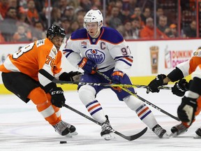 Connor McDavid #97 of the Edmonton Oilers works the puck around Pierre-Edouard Bellemare #78 of the Philadelphia Flyers in the third period at Wells Fargo Center on December 8, 2016 in Philadelphia, Pennsylvania.  (Photo by Rob Carr/Getty Images)