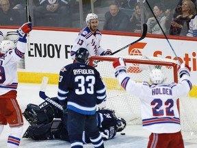 The Rangers celebrate Kevin Hayes' game winning goal against Winnipeg Jets goaltender Michael Hutchinson. (JOHN WOODS/Canadian Press)