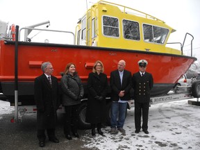 Central Elgin Mayor Dave Marr, left, St. Thomas Mayor Heather Jackson, London West MP Kate Young, Kanter Marine president Manfred Kanter Jr. and Canadian Coast Guard engineer officer Constantin Vasile celebrate the St. Thomas boat manufacturer's new $5.4 million contract with the federal government. Kanter Marine is building two survey vessels, similar to the one pictured, for the coast guard. The multimillion-dollar project will take 18 months to complete.